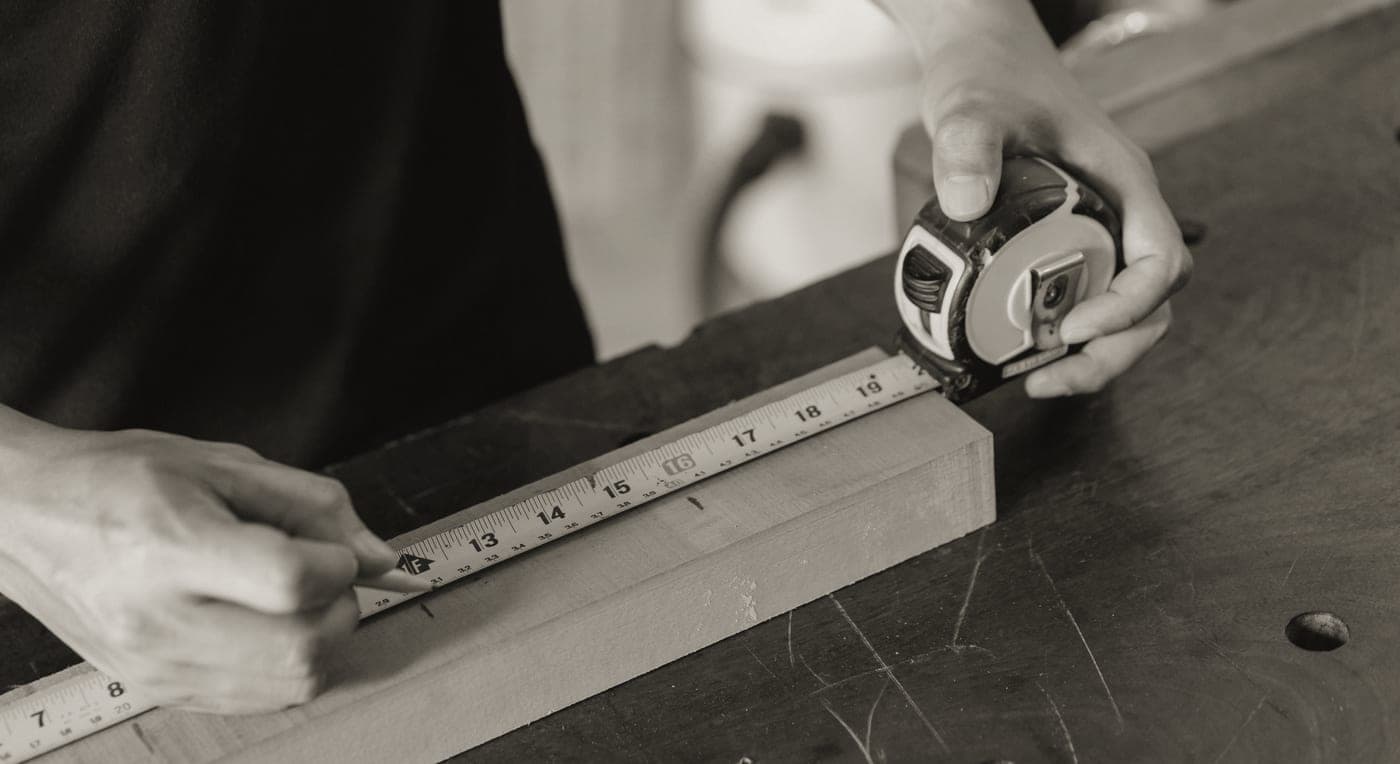 Measuring a wooden board on a kitchen counter
