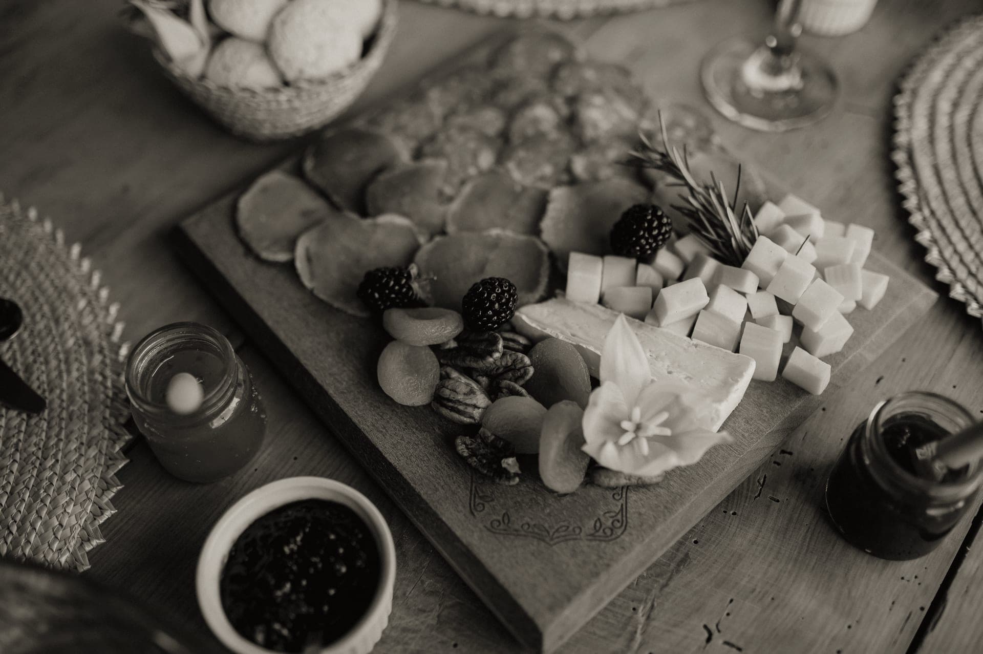 A charcuterie board of cheese, cured meats and grapes set out on a wooden table
