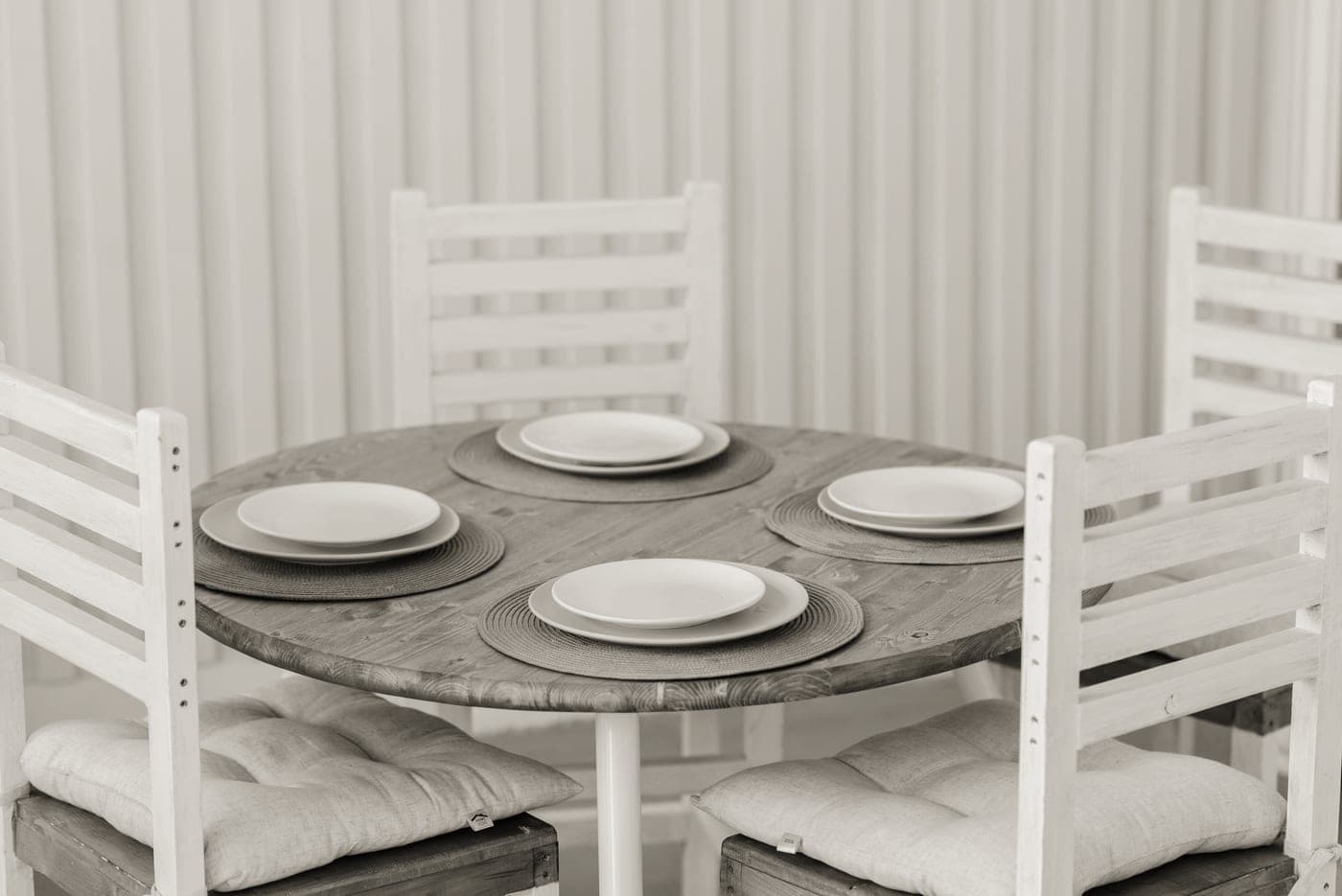 A dining table set with ceramic plates and a full place setting