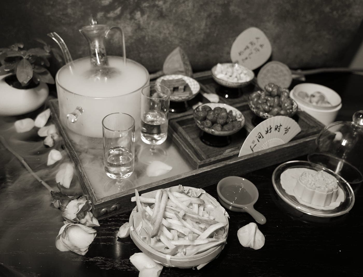 A serving tray of drinks and appetizers on a table